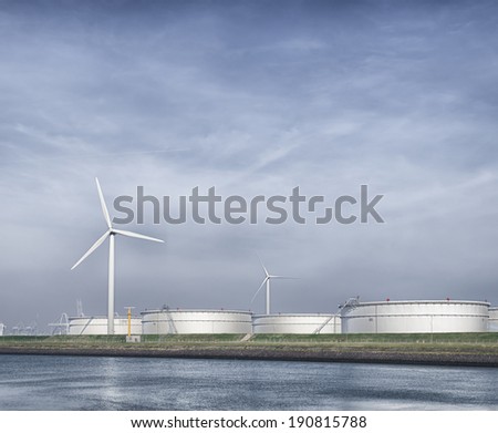 wind turbines and storage silos for petrol in the rotterdam harbor area