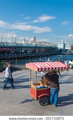 ISTANBUL - APRIL 29, 2014: Unknown street vendor selling food in at the Galata bridge. Eating on the street is part of local life here