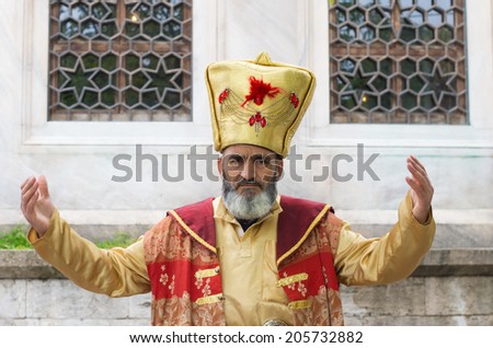 ISTANBUL - APRIL 29, 2014: Unknown turkish man in ancient oriental costume. He got paid by tourists who want to take pictures