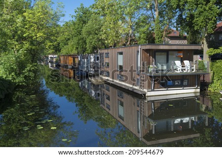 UTRECHT, NETHERLANDS - MAY 17, 2014: Floating houses in a canal. Utrecht is the fourth largest city in the netherlands with 330,000 residents
