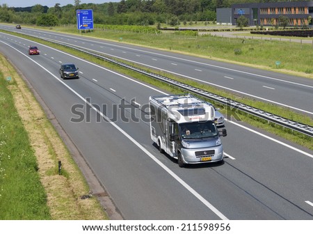 OLDENZAAL, NETHERLANDS - MAY 25, 2014: Highway with home going travelers in a camper. In the netherlands there are over 85,000 campers in 2014
