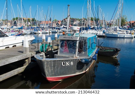 URK, NETHERLANDS - MAY 31, 2014: Small fishing boat with Urker registration number. Urk has by far the largest fishing fleet and fish processing industry in the Netherlands.