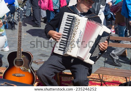 ZUTPHEN, NETHERLANDS - AUGUST 31, 2014: Unknown street artist playing his guerrini accordeon in the streets of zutphen