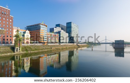 DUSSELDORF - SEPTEMBER 6, 2014: Reflection of office buildings in the media harbor. The Hafen district contains some spectacular post-modern architecture, but also some bars, restaurants and pubs
