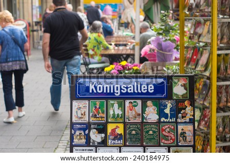 DUSSELDORF, GERMANY - SEPTEMBER 6, 2014: Konigsallee street name sign. The street is famous for the fashion showrooms and luxury retail stores located along its sides.