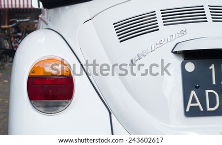 THE HAGUE, NETHERLANDS - SEPTEMBER 13, 2014: Back of a white beetle car with dutch license plate. From 1937 till 2003 there are more than 20 million cars manufactured