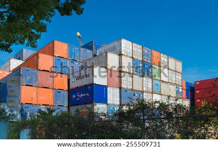 ROTTERDAM - OCTOBER 4, 2014: Piled up cargo containers in the rotterdam port. It is the largest port in Europe, covering 105 square kilometers (41 sq miles)