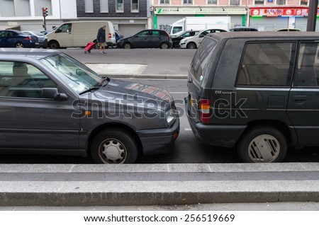 PARIS - OCTOBER 12, 2014: Close parked cars in de streets of Paris. At many insurance companies in France bumpers are not insured