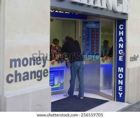 PARIS - OCTOBER 11, 2014: Unknown man changes money at a street money exchange office