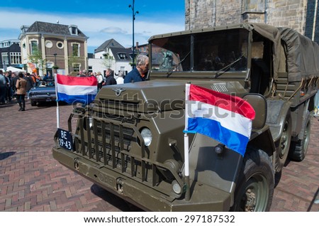 OLDENZAAL, NETHERLANDS - APRIL 27, 2015: Military vehicle with dutch flag during the 14th orange tour. This annual tour takes places during the king\'s birthday celebrations, a national holiday.