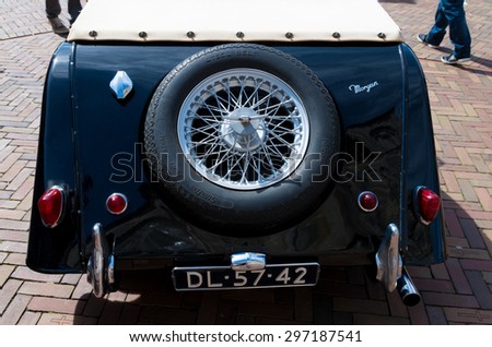OLDENZAAL, NETHERLANDS - APRIL 27, 2015: Black oldtimer car with spare wheel during the 14th orange tour. This annual tour takes places during the king's birthday celebrations, a national holiday.