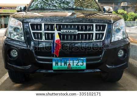 MANILA, PHILIPPINES - JUNE 7, 2015: Isuzu car with philippine flag and license plate. 2.5 million cars in Manila cause 85% of the air pollution.