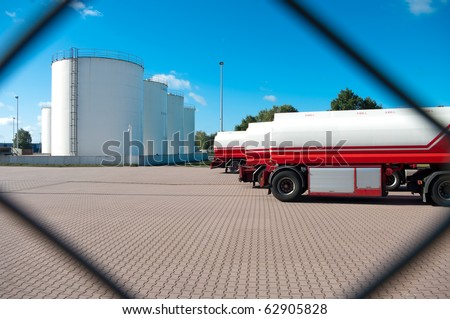 fuel tanks seen from behind a fence