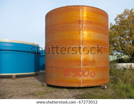 large rusty silo stored outside for further processing