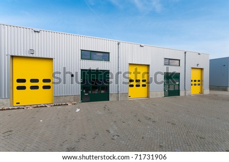 industrial warehouse with green and yellow roller doors