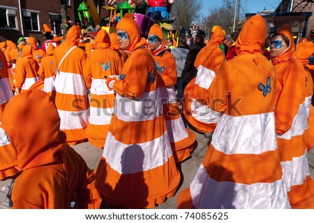 OLDENZAAL, NETHERLANDS - MARCH 6: People joining the carnival parade dressed like orange street pylons on March 8, 2011 in Oldenzaal, Netherlands.