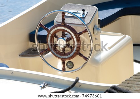 shiny metallic steering wheel of a motor boat