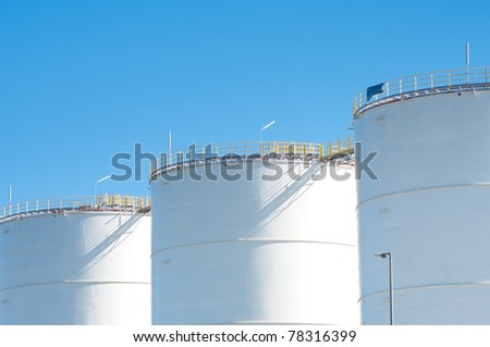 large white tanks for petrol and oil in the Rotterdam harbor