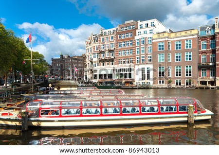 sightseeing boats in typical amsterdam canal