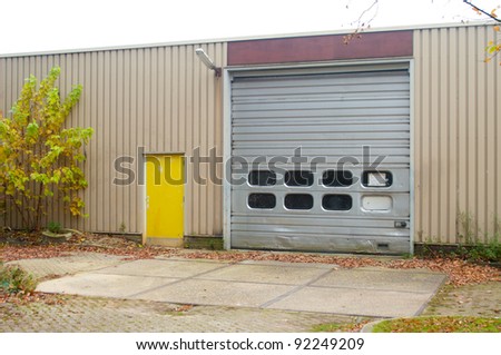 industrial warehouse with damaged roller door