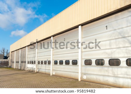 industrial unit with old and damages roller shutter doors