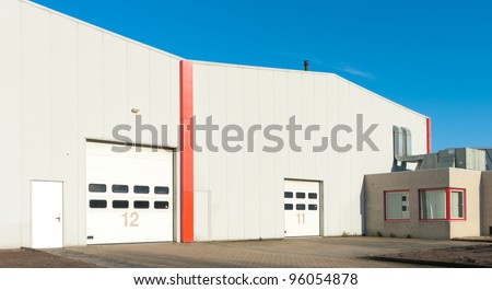 numbered industrial roller doors in a large warehouse