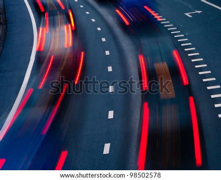 blurred lights of cars on a highway at evening