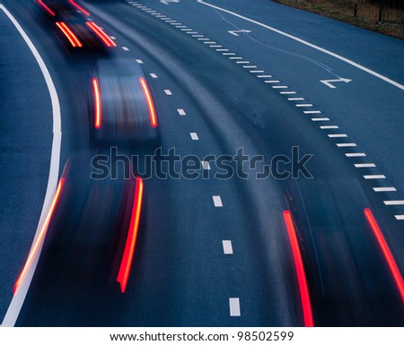 blurred lights of cars on a highway at evening