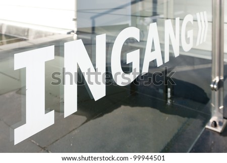 entrance sign in dutch language on a glass plate