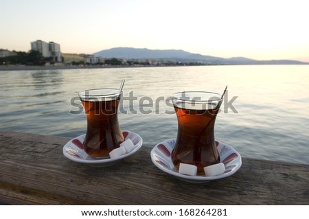 Glass of Turkish tea and Atakum Beach, Turkey-Samsun. Selective focus on tea glass.