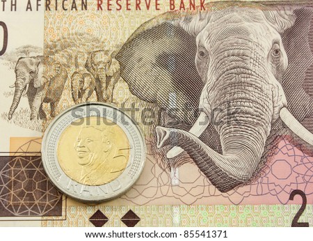 South African Currency - A Five Rand Coin with the bust Of Mandela on a Twenty Rand Note