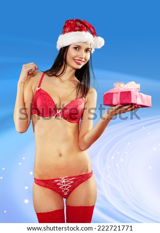Beautiful and sexy woman with gift wearing santa clause costume