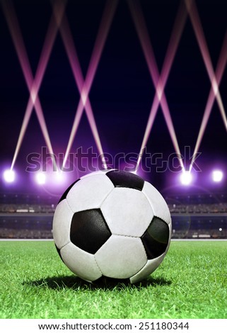soccer ball in the center of stadium during festive lighting at evening