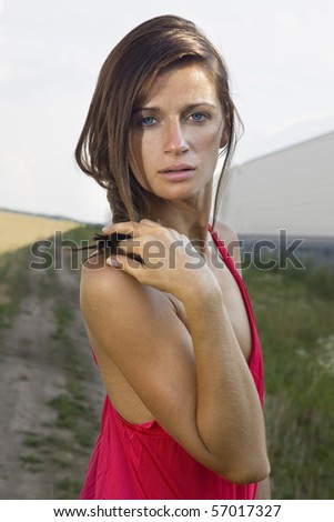 Beautiful sad woman holding lock of her hair