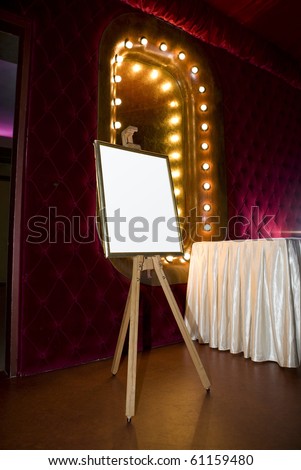 Painter easel with frame and blank canvas in retro room