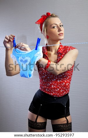 beautiful housewife hangs out shorts for drying