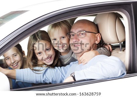 happy father with smiling children in the car