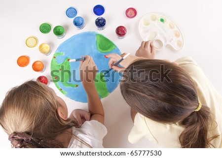 children draw colored paints globe