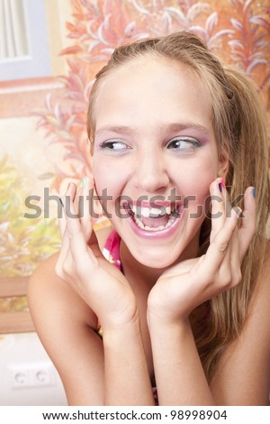 smiling beautiful caucasian girl  with hands which has color nails