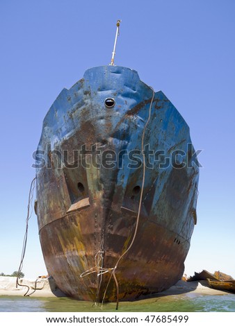 Old cargo ship washed ashore after a storm