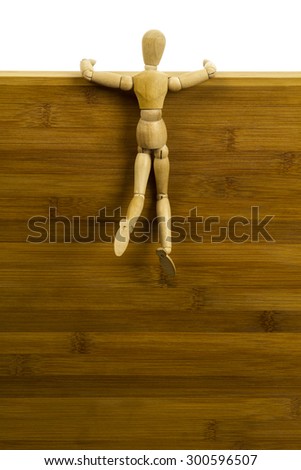 Wooden dummy hanging on a high wooden wall