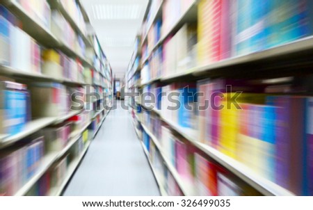 Abstract blury and dark tone color bookshelf in library
