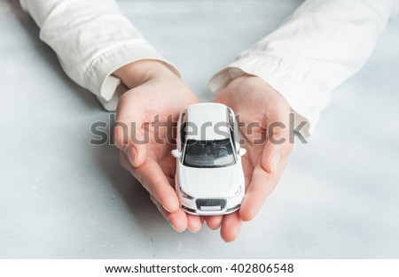 Car insurance. Automobile collision damage waiver concepts. with protective gesture and icon of car. Protection of car. Business concept. toy car and hand  isolated on white