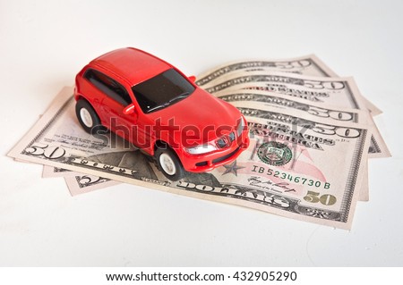 car and money. concept of car loan, Rent, car insurance, buy car Toy car and money over white.