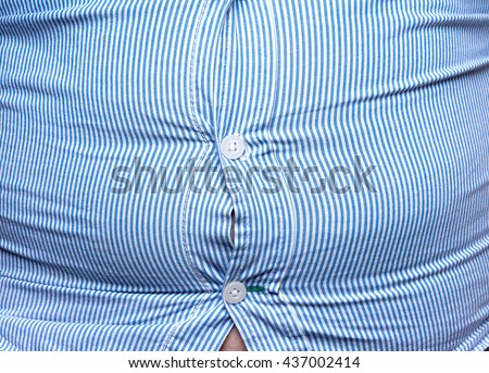 man with overweight. symbolic photo for beer belly, unsuccessful dieting and eating the wrong foods. Weight loss concept.  Tight shirt.