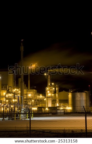 Petro Chemical Refinery Behind Fence at Night