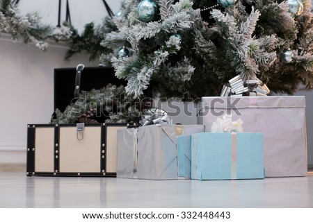 Christmas gifts under the Christmas tree in blue