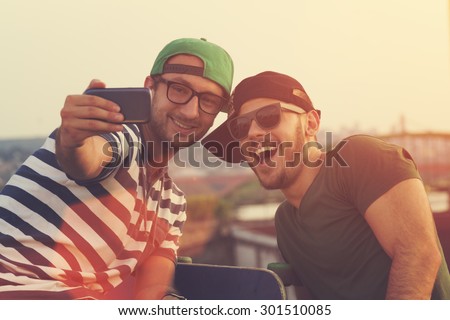 Couple of guys doing a selfie.