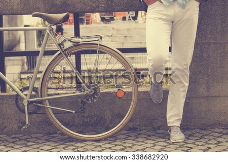 Hipster guy with old bicycle.