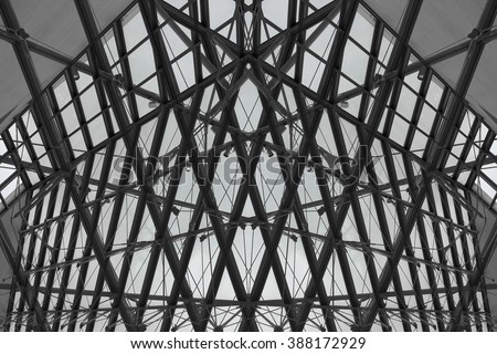 Realistic but not real fully symmetric fragment of contemporary building revealed in smart double exposition of transparent modular roof / ceiling. Fictional modern architecture in black and white.